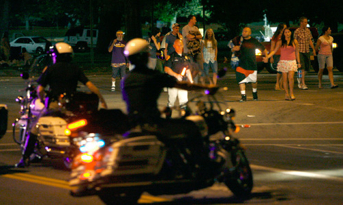 Steve Griffin  |  The Salt Lake Tribune
People leave Liberty Park as they cross 700 east with the help of Salt Lake City police officers after the fireworks show ended Saturday.