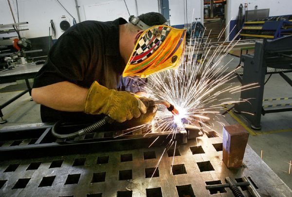 Scott Sommerdorf  l  The Salt Lake Tribune
Prototype Technician Doug Fuller works on a lower arm assembly for a 