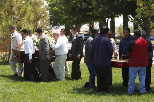 Photo by Trent Nelson  |  The Salt Lake Tribune

Pallbearers carry the casket as 