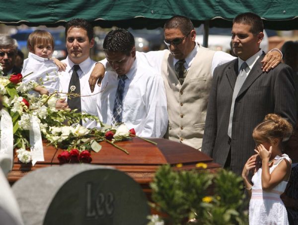 Photo by Trent Nelson  |  The Salt Lake Tribune

Sons of George Lee, left to right, are Chad Lee (holding his son Ammon Lee), Scott Lee, Dwayne Lee, and Todd Lee at graveside services for George P. Lee, in Washington, Tuesday, August 3, 2010.