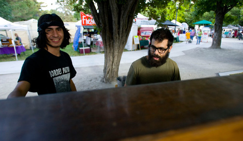 Steve Griffin  |  The Salt Lake Tribune&#xA;&#xA;Corbin Baldwin, left, and Eric Rich with their upright grand piano at the farmer's market in Salt Lake City on Saturday, August 7, 2010. The 