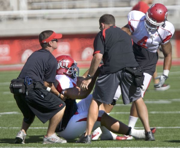 Al Hartmann  |  The Salt Lake Tribune

Ute trainers help running back Shawn Asiata up after a hard hit during scrimmage Tuesday Rice-Eccles Stadium.