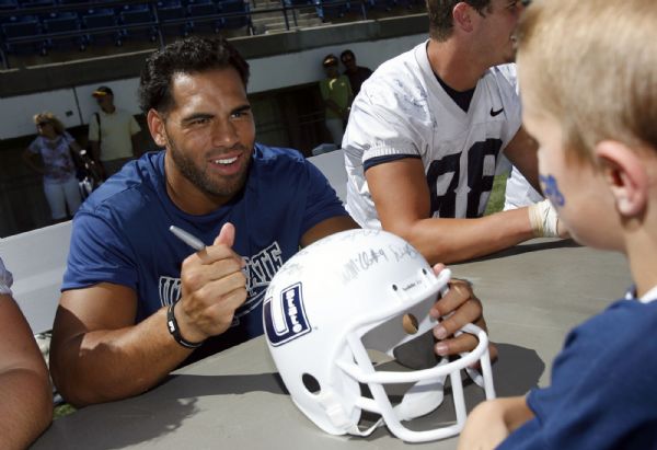 Francisco Kjolseth  |  The Salt Lake Tribune
Linebacker, Matt Ah You who is in a sixth season of eligibility at Utah State and is a former starter at BYU signs his autograph for a young fan following a scrimmage for Family Fun Day in Logan on Saturday, Aug. 21, 2010.
Logan. Aug. 21, 2010.