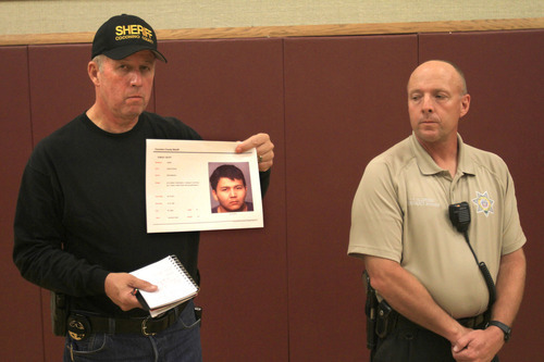 Jim Driscoll, Chief Deputy for Coconino County Arizona,  holds a
photo of Suspect Scott Curley, at a press conference at an LDS church in Fredonia, at 1 a.m. Friday.  Kane County Sgt. Alan Alldredge is on the right. (Rick Egan/The Salt Lake Tribune)