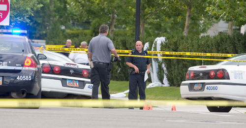 Paul Fraughton  |  The Salt Lake Tribune
Police investigate a shooting at the corner of 600 South and State Street in Salt Lake City. An officer was shot by an armed man who was shot and killed by the officer Friday near the Grand America hotel.
