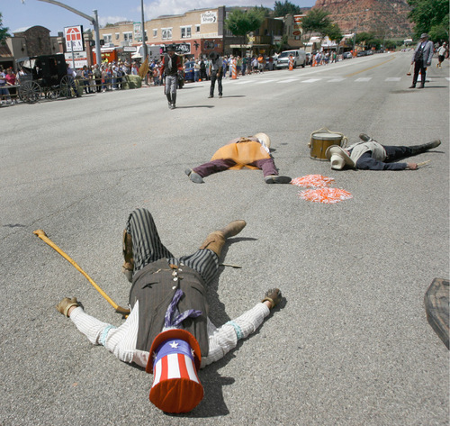 Rick Egan  |  The Salt Lake Tribune

Western characters pretend to lie dead on Main street in Kanab after a fake gun battle during the Western Legends Round Up on Saturday.