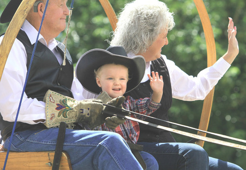 Rick Egan  |  The Salt Lake Tribune

J.W. Reese, 2, rides in a wagon with J. Ryan Miller and
Suzanne Miller of Herriman, UT during the parade at the Western Legends
Round Up on Saturday in Kanab.