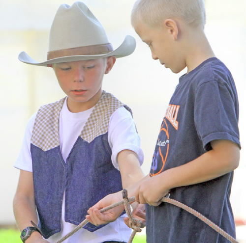 Rick Egan  |  The Salt Lake Tribune

Brayden Poldsen, 10, of St. George, gives Jacob Larsen, 7, also of St. George, lessons on roping during the Western Legends Round Up on Saturday in Kanab.