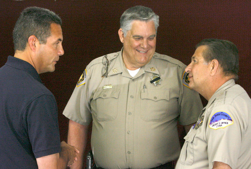 Rick Egan   |  The Salt Lake Tribune
Law enforcement officers were all smiles at a news conference at the Kanab Fire Station Monday to announce the capture of Scott Curley. Supervisor Deputy U.S. Marshal Mike Wingert, from left, Kane County Sheriff Lamont Smith and Mike Lacy, San Juan Sheriff's department, talk about the capture after the news conference.