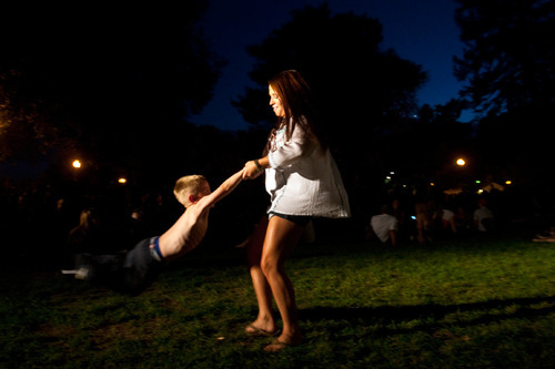 Chris Detrick  |  The Salt Lake Tribune &#xA;Kendra Gille swings around Liam Riding, 4, during the She and Him performance at the final Twilight Concert at Pioneer Park on Aug. 26, 2010.