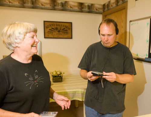 Paul Fraughton  |  The Salt Lake Tribune&#xA;Mary Paulsen smiles after she gave  her son Philip Miller, who is severely disabled with autism, a new portable radio. He was moving into the Utah State Developmental Center in  American Fork on Wednesday, August 25, 2010