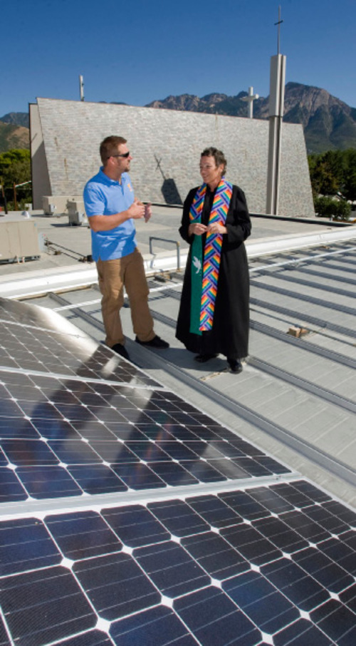 Al Hartmann  |  Salt Lake Tribune&#xA;Jason Allen an electrician and installer for Alpenglow Solar, left, shows Reverend Dr. Marti Zimmerman, the senior pastor at Christ United Methodist Church at 2374 East 3300 South its new array of rooftop solar panels that are up and running.   The church got funding from Rocky Mountain Power's Blue Sky renewable-energy program.  It's estimated the new panels will supply 20 to 30 per cent of the church's electrical needs.