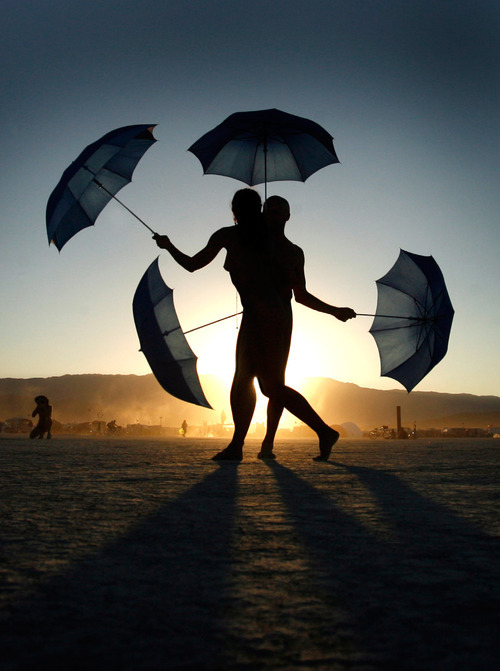 Rick Egan   |  The Salt Lake Tribune&#xA;&#xA;Umbrella dancers at dusk, at the Burning Man Festival, Saturday, Sept. 4, 2010.