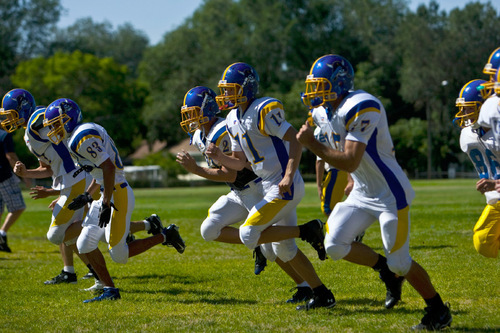 Chris Detrick  |  The Salt Lake Tribune &#xA;Members of the Cyprus football team run during a practice at Cyprus High School Tuesday September 7, 2010.