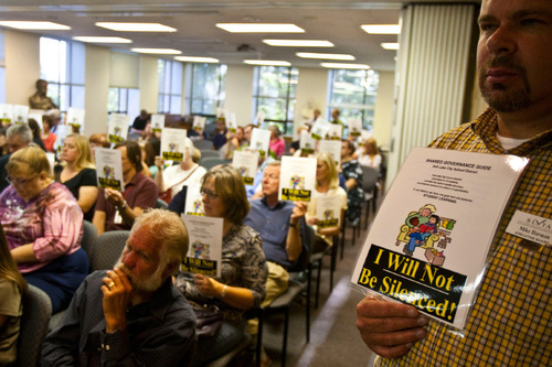 Chris Detrick  |  The Salt Lake Tribune &#xA;Salt Lake District counselor Mike Harman holds a sign reading 'I Will Not Be Silenced!' during a Salt Lake City School District board meeting Tuesday September 7, 2010. Last month, the school board modified the high-school block schedule. The Salt Lake Teachers Association says the decision was made without 