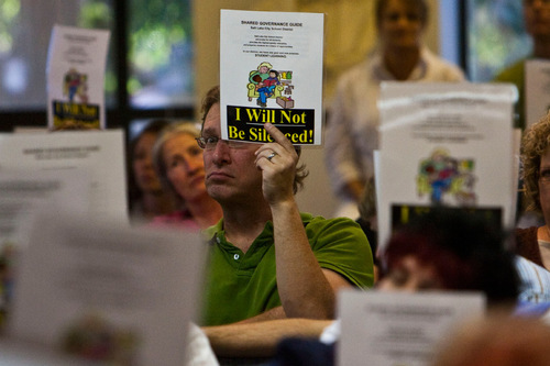 Chris Detrick  |  The Salt Lake Tribune &#xA;Whittier Elementary School teacher Geoff Griffin holds a sign reading 'I Will Not Be Silenced!' during a Salt Lake City School District board meeting Tuesday September 7, 2010. Last month, the school board modified the high-school block schedule. The Salt Lake Teachers Association says the decision was made without 