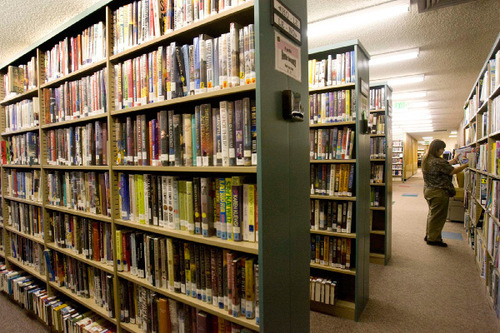 Paul Fraughton  |  The Salt Lake Tribune&#xA; A visitor to the Davis County library in  Farmington pulls out a book from the crowded shelves  on  Friday, Sept. 3, 2010. A new library is in the works as part of a  complete renovation of the Davis County campus facilities.