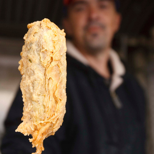 Trent Nelson  |  The Salt Lake Tribune
6. The finished product. Kevin Larose demonstrates the process of creating a deep-fried pickle at the Utah State Fair on Thursday, Sept. 9, 2010 in Salt Lake City.