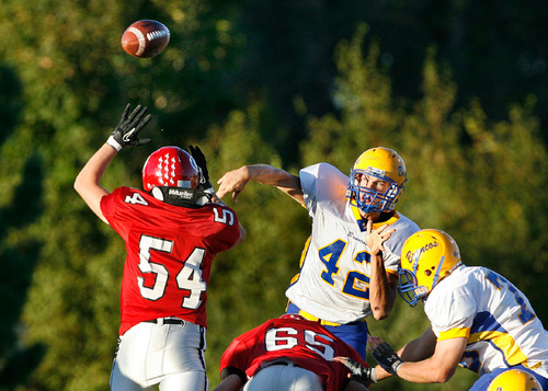 Scott Sommerdorf  l  The Salt Lake Tribune&#xA;San Juan QB Cameron Shumway (42) throws over the defensive pressure from Grantsville's LB Dalton Stice (54) during first half play. The 2A San Juan Broncos beat the 3A Grantsville Cowboys 18-7, Friday, September 10, 2010.