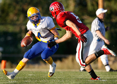 Scott Sommerdorf  l  The Salt Lake Tribune&#xA;San Juan WR Tyler Nielson runs after a catch against Grantsville's DB Derek Jensen (5) during first half play. The 2A San Juan Broncos beat the 3A Grantsville Cowboys 18-7, Friday, September 10, 2010.