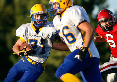 Scott Sommerdorf  l  The Salt Lake Tribune&#xA;San Juan's RB Ryan Lyman runs away from Grantsville's DE Kelby Landon (6) during first half play. The 2A San Juan Broncos beat the 3A Grantsville Cowboys 18-7, Friday, September 10, 2010.