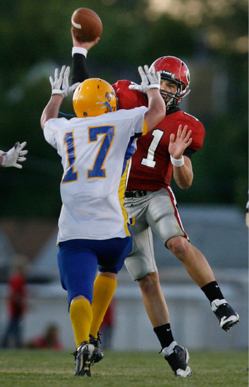 Scott Sommerdorf  l  The Salt Lake Tribune&#xA;Grantsville QB Bridger Bowman (11) leaps to pass over San Juan's Kevin Arthur during first half play. The 2A San Juan Broncos beat the 3A Grantsville Cowboys 18-7, Friday, September 10, 2010.