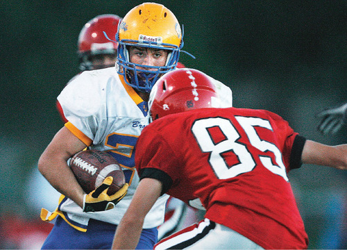 Scott Sommerdorf  l  The Salt Lake Tribune&#xA;San Juan's Ryan Lyman (21) eyes Grantsville DB Lincoln Kelley (85) as he runs the ball during first half play. The 2A San Juan Broncos beat the 3A Grantsville Cowboys 18-7, Friday, September 10, 2010.