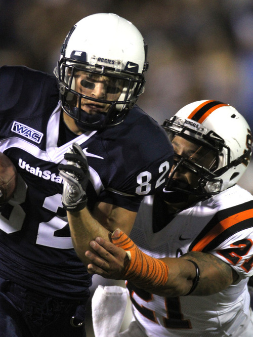 Rick Egan   |  The Salt Lake Tribune&#xA;&#xA;Eric Moats, (82) ) runs the ball for the Aggies , as Chris Holmsley (21)   defends for Idaho State, in football action,  Utah State vs. Idaho State football game, Saturday, September 11, 2010.