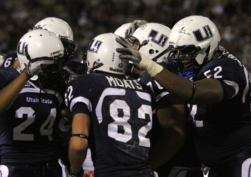 Rick Egan   |  The Salt Lake Tribune&#xA;&#xA;Aggie team mates congratulate Eric Moats, (82) after his scored a touchdown  for the Aggies in football action,  Utah State vs. Idaho State football game, Saturday, September 11, 2010.