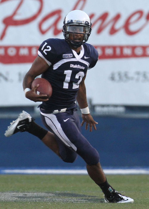 Rick Egan   |  The Salt Lake Tribune&#xA;&#xA;QB Diondre Borel (12) runs the ball for the Aggies, in football action,  Utah State vs. Idaho State football game, Saturday, September 11, 2010.