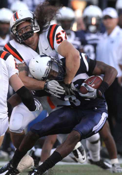 Rick Egan   |  The Salt Lake Tribune&#xA;&#xA;Bengals Justin Vae'ena (57) grabs Dontel Watkins (85)  as he runs the ball for the Aggies, in football action,  Utah State vs. Idaho State football game, Saturday, September 11, 2010.