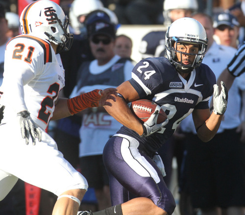 Rick Egan   |  The Salt Lake Tribune&#xA;&#xA;Chris Holmsley (21) defends for the Bengals, as Austin Alder runs the ball for the Aggies, in football action,  Utah State vs. Idaho State football game, Saturday, September 11, 2010.