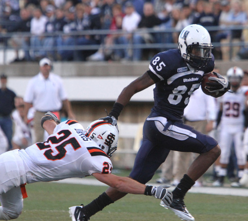 Rick Egan   |  The Salt Lake Tribune&#xA;&#xA;Tanner Davis (25) grabs Dontel Watkins (85)  as he runs the ball for the Aggies, in football action,  Utah State vs. Idaho State football game, Saturday, September 11, 2010.