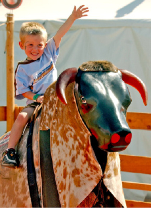 Rick Egan/The Salt Lake Tribune

Adam Stewart, 4, West Jordan, rides a mechanical bull at the Utah State Fair in 2004.