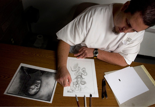 Steve Griffin  |  The Salt Lake Tribune&#xA; &#xA;Inmate art instructor Bret Lindeman takes a break from teaching as he works on a drawing of an alien during art class at the Utah State Prison in Riverton Tuesday, September 7, 2010.
