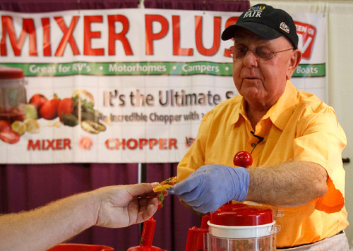 Leah Hogsten  |  The Salt Lake Tribune&#xA;Bradley Leyman from Los Angeles, CA hands out tortilla chips loaded with his just made pico de gallo salsa to demonstrate the powers of the Mixer Plus. The Utah State Fair features unique commercial sales booths that feature barkers pitching magic pans, Ginza knifes, funeral packages and shower and tub inserts in Salt Lake City on Tuesday, September 14, 2010.