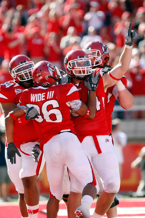 Chris Detrick  |  The Salt Lake Tribune &#xA;Utah Utes running back Shawn Asiata, No. 34, running back Eddie Wide, No. 36, and tight end Brad Clifford, No. 84, celebrate after Wide scored a touchdown Sept. 11 in a game against UNLV.
