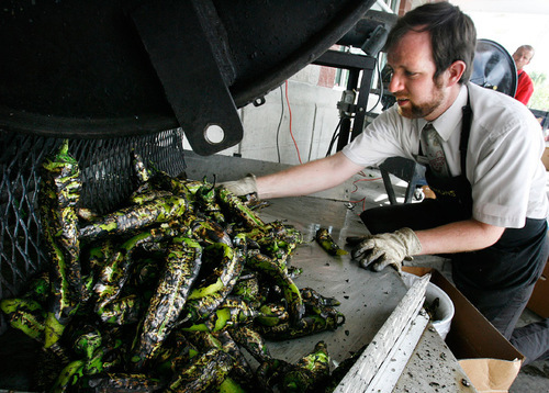 Scott Sommerdorf  l  The Salt Lake Tribune
Travis Riches unloads a batch of freshly roasted chiles at Harmon's, Friday Aug. 27, 2010. Harmon's grocery stores are roasting fresh, locally-grown Anaheim chile peppers every weekend this fall. The peppers are roasted in large metal drums outside the store. This is a tradition in New Mexico that has made its way to Utah.