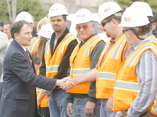 RICK EGAN  | Salt Lake Tribune File Photo
Gary Herbert is pictured here last March shaking hands with workers from Provo River Contractors, as he kicked off the I -15 expansion (I-15 Core) project. Controversy has arisen over a $13 million payment to a losing bidder and allegations of favoritism to campaign donors by gubernatorial candidate Peter Corroon.