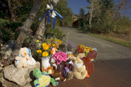 Leah Hogsten  |  The Salt Lake Tribune
Flowers are piled up outside the Warhola home in Layton. The Layton east bench neighborhood  signed and hung a banner in honor of James and Jean Warhola, siblings who were allegedly killed by their mother. They were buried Friday in Salt Lake City. Sun Cha Warhola, 44, is charged with aggravated murder -- which carries the potential for the death penalty -- for allegedly killing her 8-year-old son, James, and 7-year-old daughter, Jean.