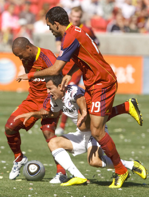 Leah Hogsten  |  The Salt Lake Tribune &#xA;Real's #77 Andy Williams (left) and Pablo Campos dominate Chicago's Marco Pappa who falls on the field. &#xA;Real Salt Lake defeated the Chicago Fire 1-0  at Rio Tinto Stadium Saturday, September 18, 2010, in Sandy.