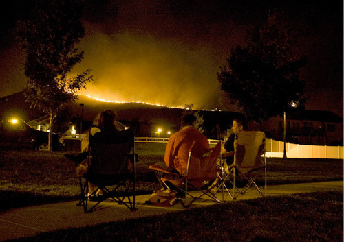 Djamila Grossman  |  The Salt Lake Tribune&#xA;&#xA;Erika Iverson, Casey Holley and Brent Nielsen watch from lawn chairs as a wildfire burns along a ridgeline above Herriman, September 19, 2010.  People throughout the area were evacuated and some houses burned down.