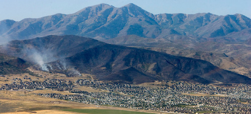 Steve Griffin  |  The Salt Lake Tribune&#xA; &#xA;The mountain side south west of Herriman is burned black Monday, September 20, 2010. Crews continued to battle the blaze Monday morning.