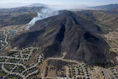 Steve Griffin  |  The Salt Lake Tribune
 
The mountain side south west of Herriman is burned black Monday, Sept. 20, 2010, but flames were stopped short of all but four homes in this subdivision.
