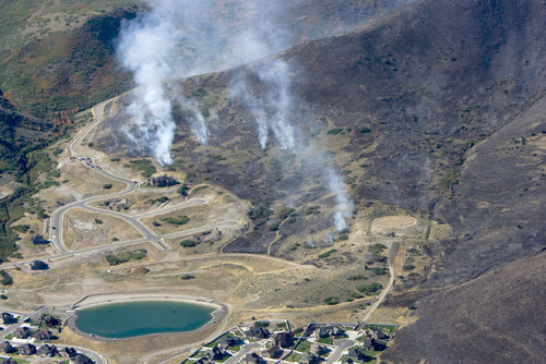 Steve Griffin  |  The Salt Lake Tribune&#xA; &#xA;The mountain side southwest of Herriman is burned black Monday, Sept. 20, 2010 as crews continued to battle the blaze.