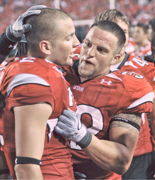 Teammates congratule Utah safety Brian Blechen, left, who is starting to become a commonplace at Ute games. Blechen, just a freshman, has emerged as a force at strong safety. Tribune file photo by Michael Mangum.