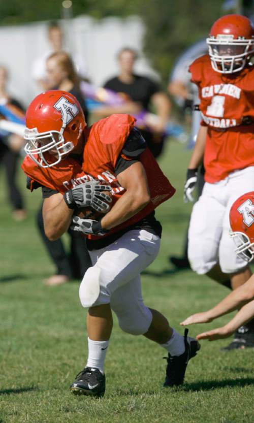 Francisco Kjolseth  |  The Salt Lake Tribune&#xA;Trinity Devereaux with American Fork pushes the ball down field during a recent practice. American Fork looked like one of the worst teams in 5A early in the football season. After scoring just 27 points through its first three games, it didn't look like the team was adjusting to first-year coach Aaron Behm's new option offense. But in region 4 games, American Fork has bested Cyprus and darling Jordan. Could it be that the Utah County school might actually be a playoff team by the end of the year?&#xA;American Fork, Sept. 21, 2010.