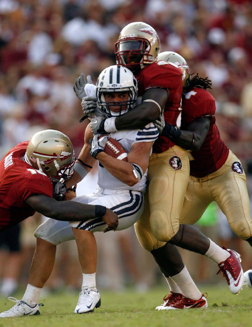 Trent Nelson  |  The Salt Lake Tribune
BYU running back JJ Di Luigi (10) is stopped by Florida State defenders Nick Moody (left) and Kendall Smith during the second half, BYU vs. Florida State, college football Saturday, September 18, 2010 at Doak Campbell Stadium in Tallahassee, Florida.