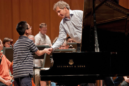 Michael Mangum  |  The Salt Lake Tribune
Music Director Thierry Fischer greets Anthony Cheng at a rehearsal with the Utah Symphony at Abravanel Hall in Salt Lake City on Monday, September 20, 2010. The Salute to Youth performance will feature nine local soloists and will be held on Tuesday, September 28, 2010.