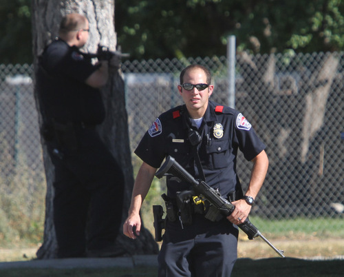 Rick Egan   |  The Salt Lake Tribune&#xA;West Valley City police stand ready during a standoff with an armed man in the 4000 block of Ivana Street on Friday afternoon.